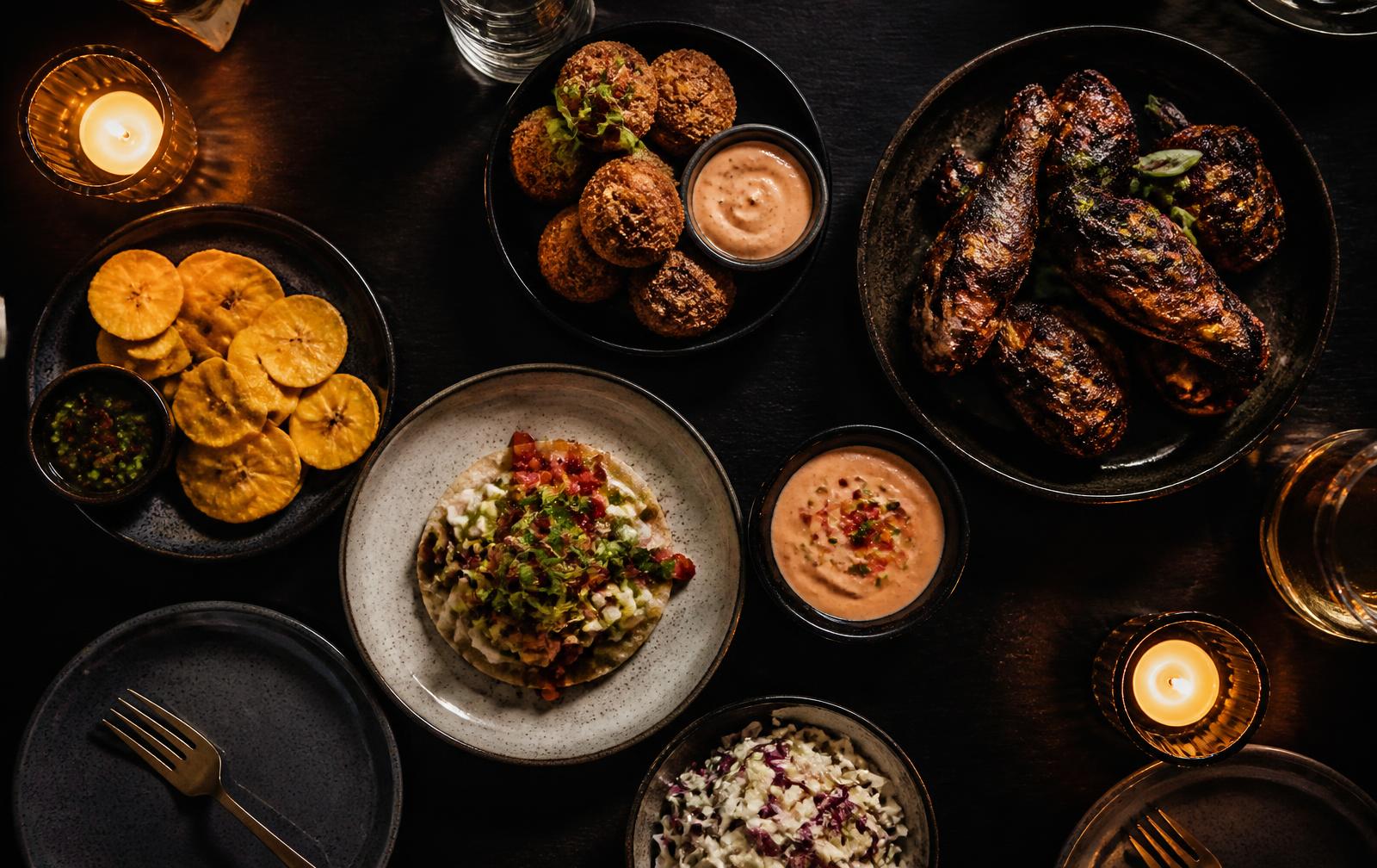 Sharing plates spread across a dark table